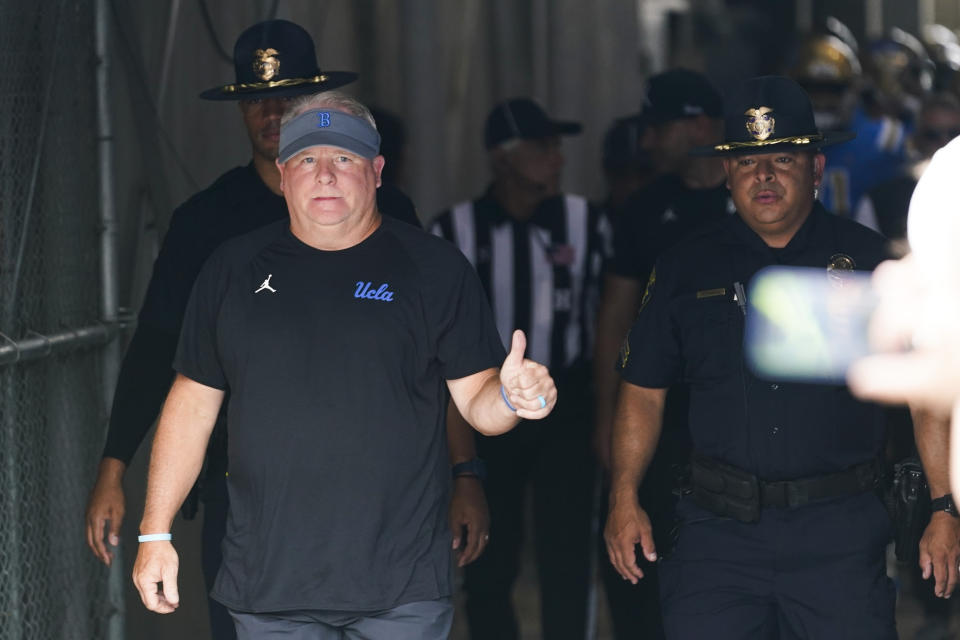 UCLA head coach Chip Kelly gives a thumbs up as he enters the field before an NCAA college football game against Alabama State in Pasadena, Calif., Saturday, Sept. 10, 2022. (AP Photo/Ashley Landis)