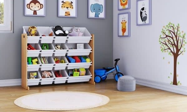 Toy organizer with multiple bins in a child's room, surrounded by wall art and a toy scooter