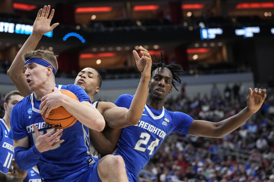 Creighton guard Baylor Scheierman (55) comes down with the rebound against San Diego State forward Jaedon LeDee in the second half of a Elite 8 college basketball game in the South Regional of the NCAA Tournament, Sunday, March 26, 2023, in Louisville, Ky. (AP Photo/John Bazemore)