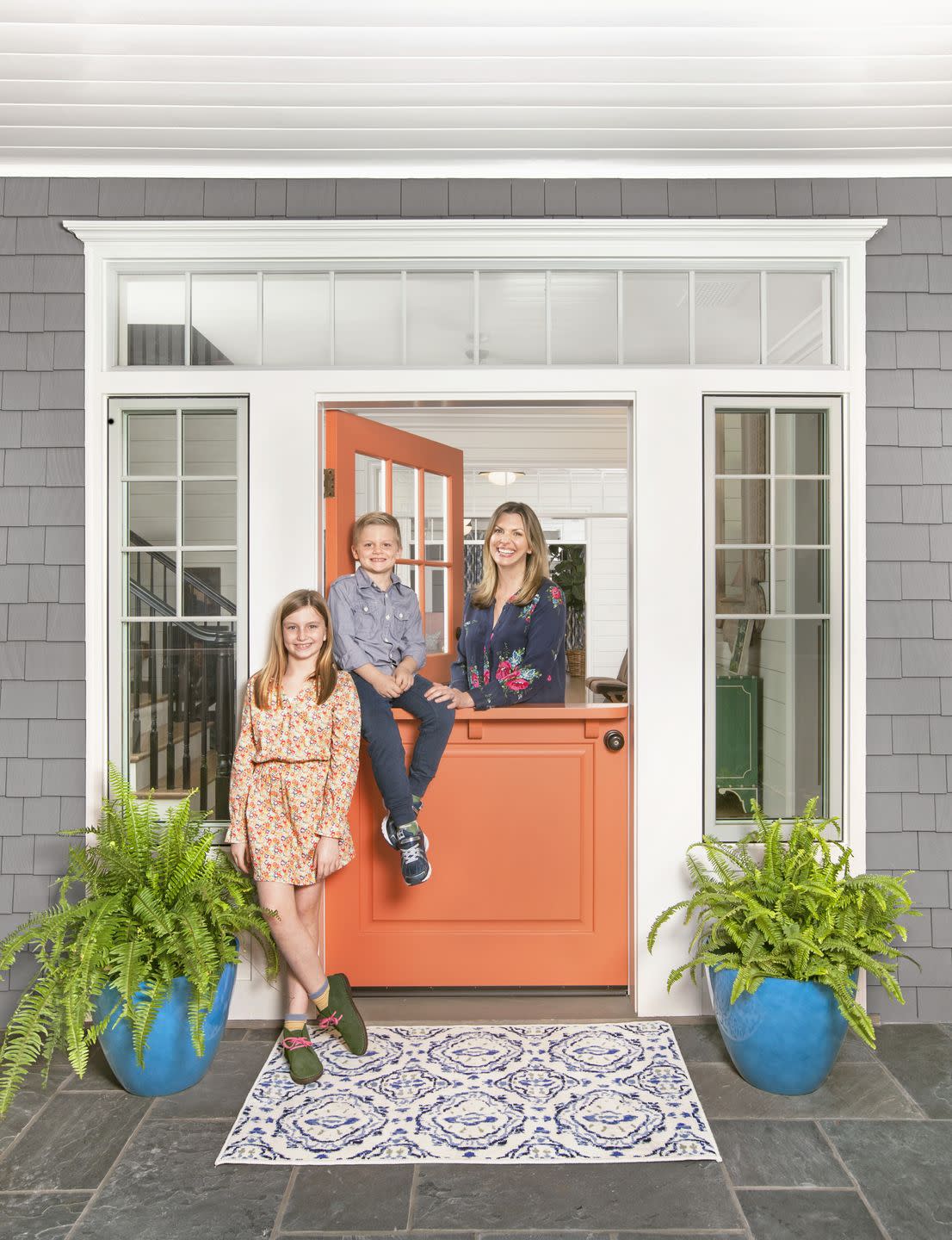 gray house with pomegranate orange door