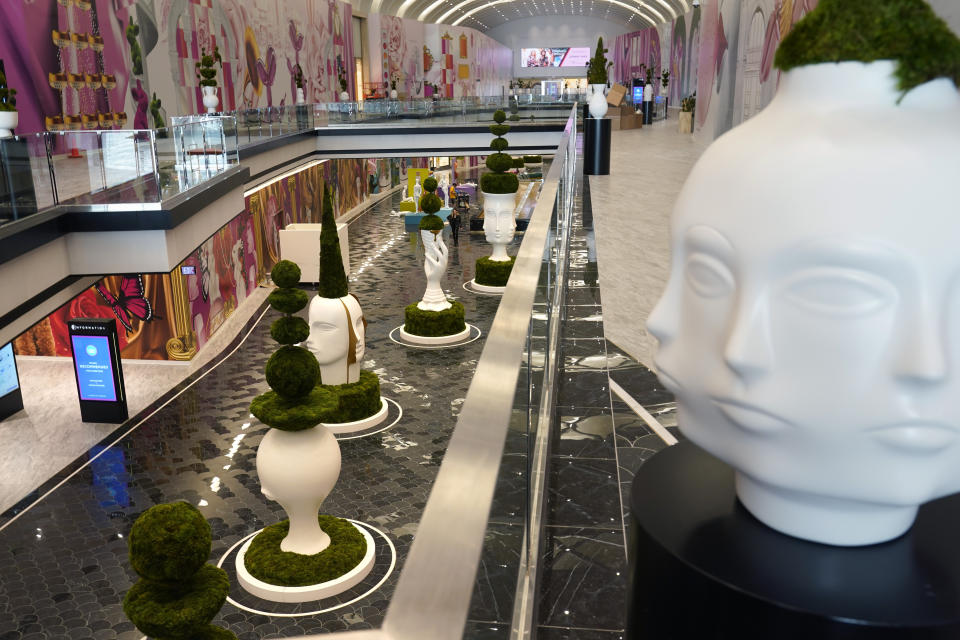 Sculptures by Jonathan Adler are displayed in The Avenue, a luxury shopping wing of the American Dream mall, before its grand opening in East Rutherford, N.J., Wednesday, Sept. 15, 2021. If you build it during a pandemic, will they still come? American Dream put that to the test when it opened the new luxury shopping wing of its megamall in September. The new wing comes as the world grapples with the highly contagious delta variant of the coronavirus, which continues to threaten life — and business — from returning to normal. (AP Photo/Seth Wenig)