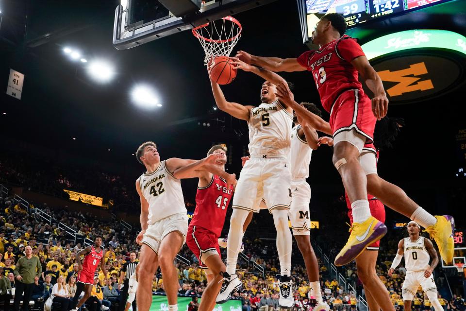 Michigan forward Terrance Williams II (5) pulls down a rebound from Youngstown State forward Jaylen Bates (13) in the first half at Crisler Center in Ann Arbor on Friday, Nov. 10, 2023.