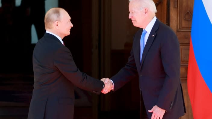 Vladimir Putin, Joe Biden. DENIS BALIBOUSE/POOL/AFP via Getty Images