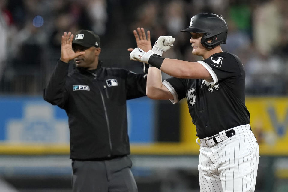 Chicago White Sox's Andrew Vaughn celebrates his three-run double off Boston Red Sox starting pitcher Michael Wacha as second base umpire Alan Porter calls time during the third inning of a baseball game Thursday, May 26, 2022, in Chicago. (AP Photo/Charles Rex Arbogast)