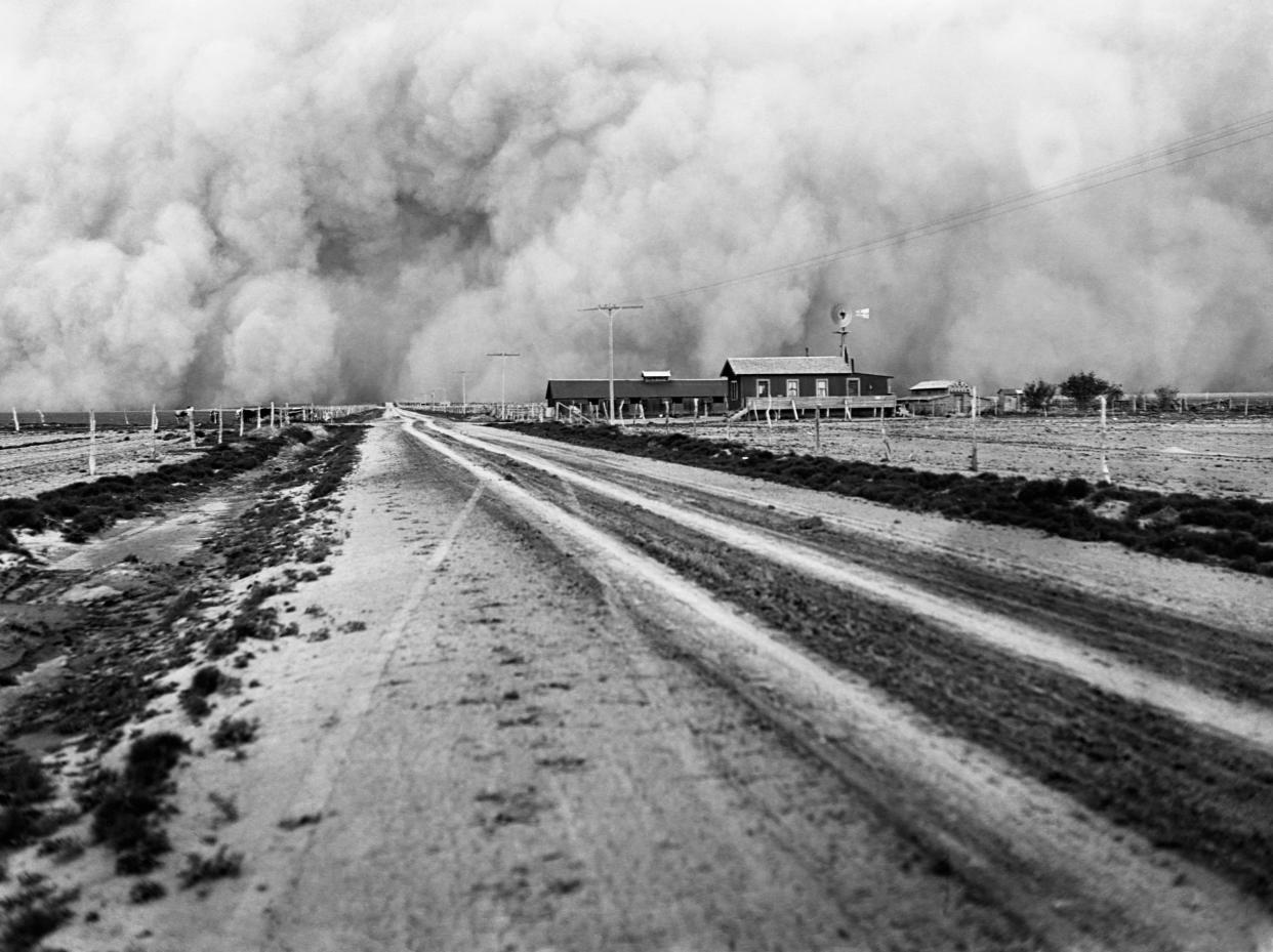 A farm about to be engulfed by a dust storm in the 1930s.