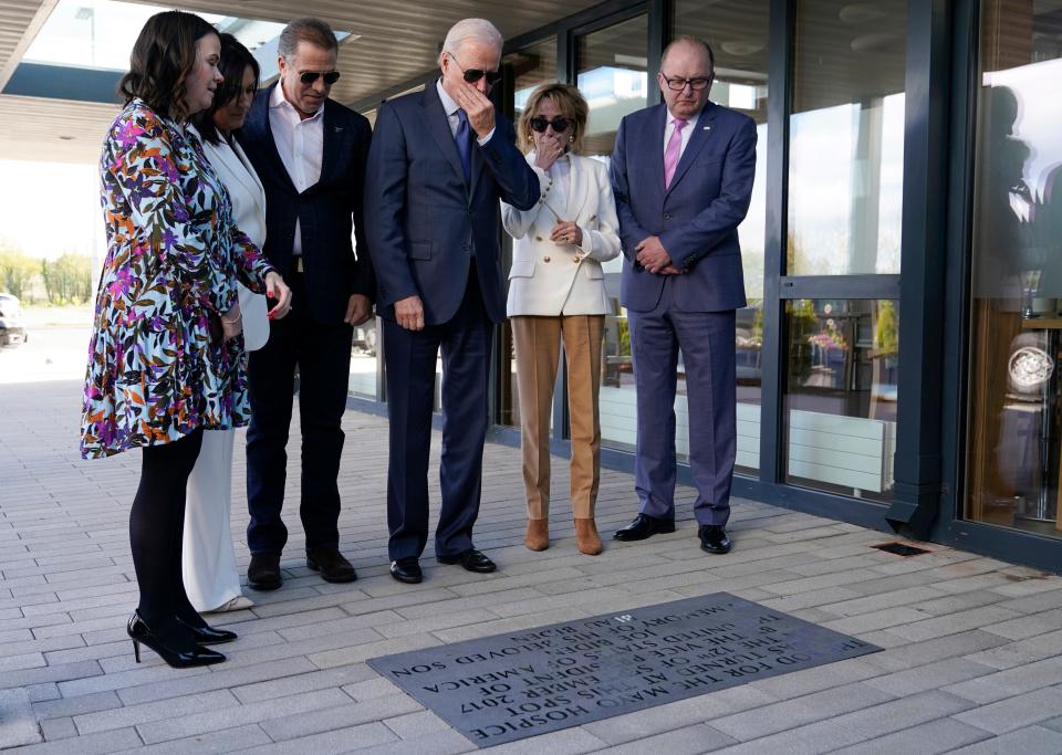 President Joe Biden stands with his son Hunter Biden and sister Valerie Biden Owens, second from right, as he looks at a plaque dedicated to his late son Beau Biden while visiting Mayo Roscommon Hospice in County Mayo, Ireland, Friday, April 14, 2023. Biden is joined by Mayo Roscommon Hospice Foundation board member Laurita Blewitt, left, CEO Martina Jennings, second from left, and Chairman Mike Smith, right. (AP Photo/Patrick Semansky)