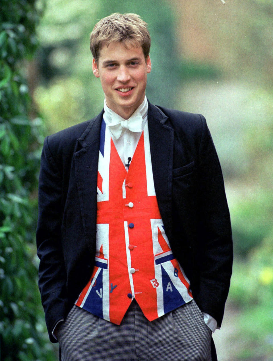 FILE - Britain's Prince William, wearing a Union Jack waistcoat, poses for a photo in this 2000 photo in Eton, England. The world watched as Prince William grew from a towheaded schoolboy to a dashing air-sea rescue pilot to a father of three. But as he turns 40 on Tuesday, June 21, 2022, William is making the biggest change yet: assuming an increasingly central role in the royal family as he prepares for his eventual accession to the throne. (Ian Jones, Pool Photo via AP, File)