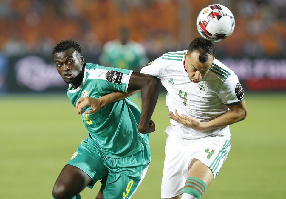 Senegal's Mbaye Hamady Niang, left, and Algeria's Djamel Eddine fight for the ball during the African Cup of Nations final soccer match between Algeria and Senegal in Cairo International stadium in Cairo, Egypt, Friday, July 19, 2019. (AP Photo/Ariel Schalit)