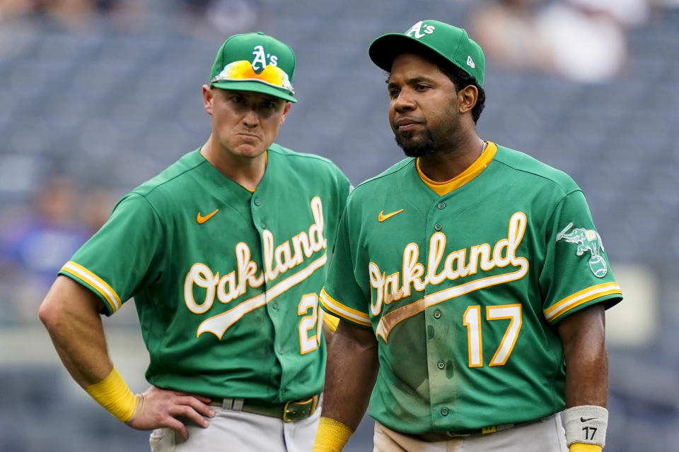 Oakland Athletics shortstop Elvis Andrus (17) and third baseman Matt Chapman, left, react after New York Yankees' Gio Urshela hit a go-ahead solo home run in the eighth inning of a baseball game, Saturday, June 19, 2021, in New York. (AP Photo/John Minchillo)