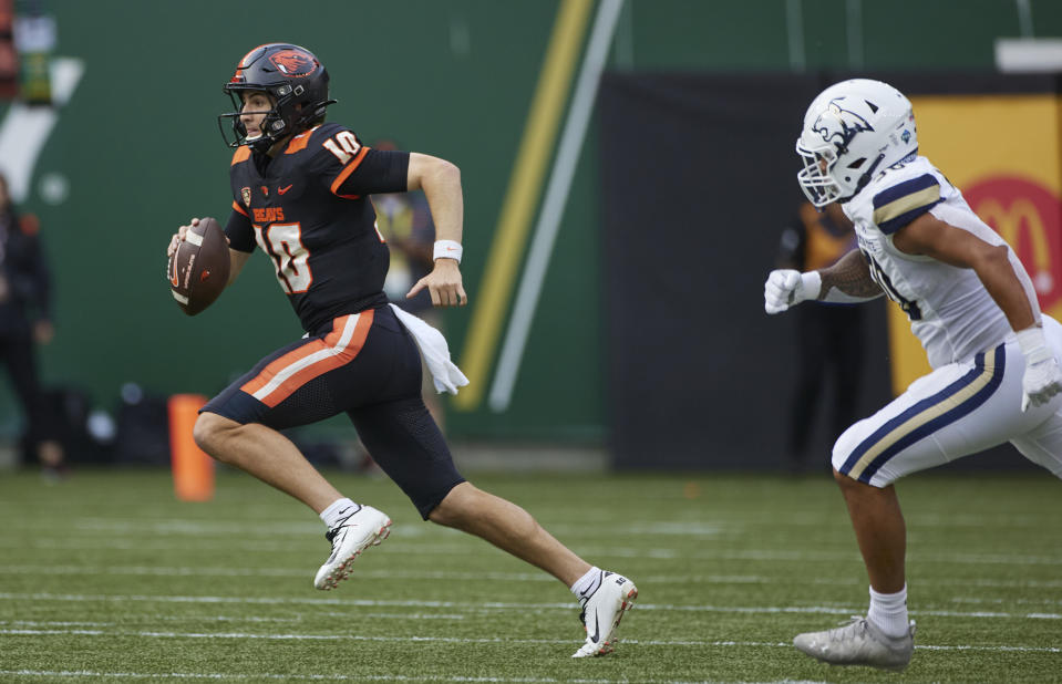 Oregon State quarterback Chance Nolan runs away from Montana State linebacker Danny Uluilakepa during the first half of an NCAA college football game in Portland, Ore., Saturday, Sept. 17, 2022. (AP Photo/Craig Mitchelldyer)