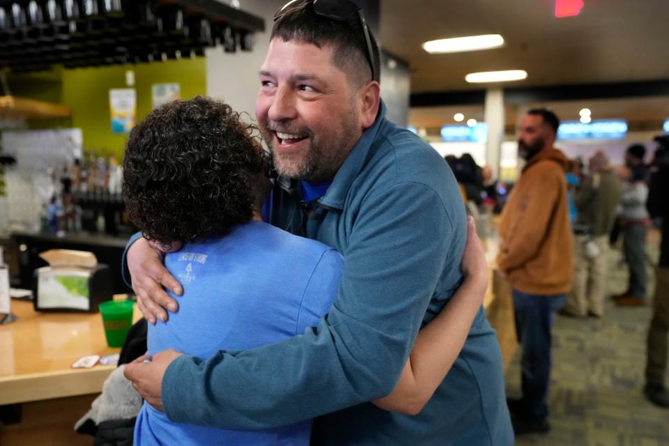 Justin Juray, owner of Just In Time Recreation, greets a customer during the reopening of the bowling alley six months after a deadly mass shooting, Friday, May 3, 2024, in Lewiston, Maine. (AP Photo/Robert F. Bukaty)