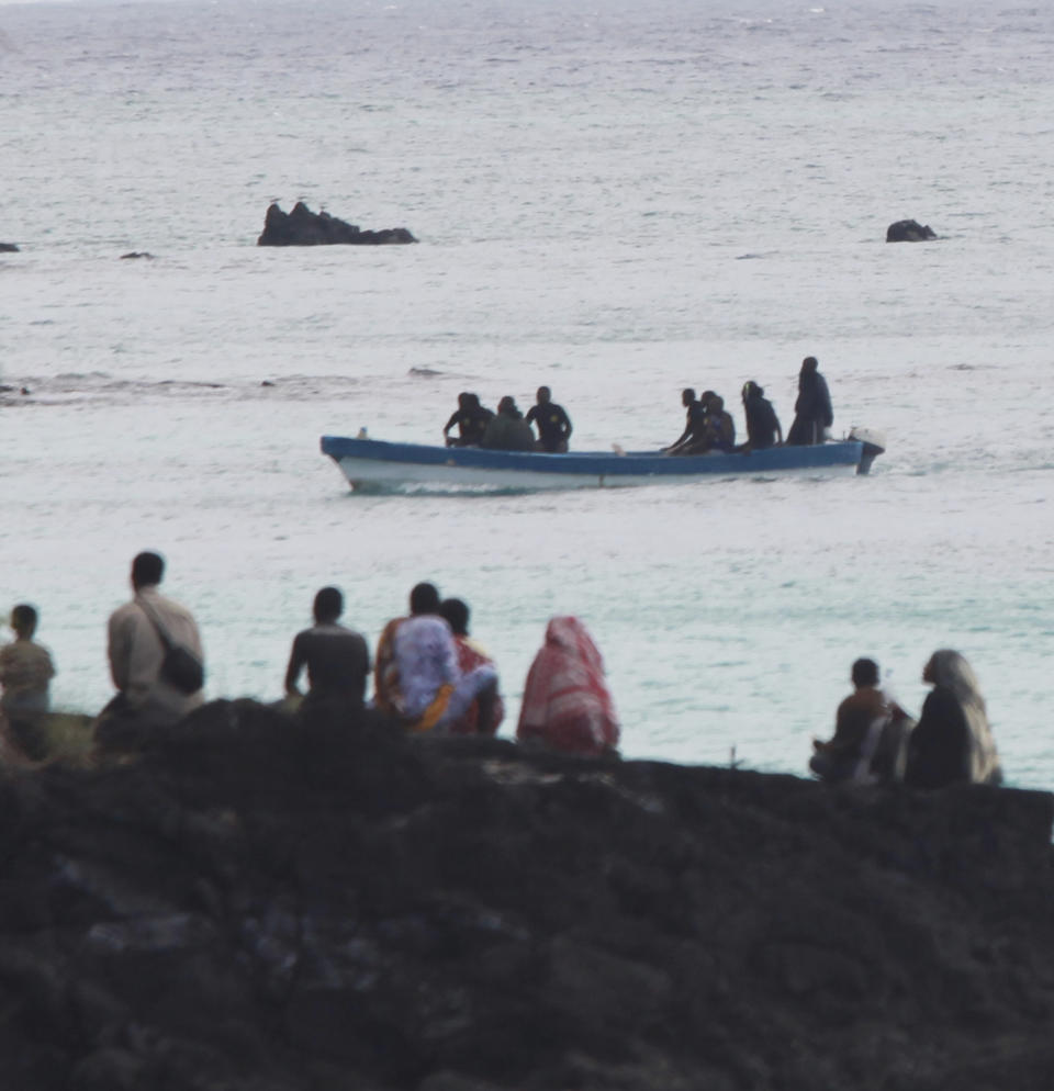 FILE - Rescuers at Galawa Beach, 22 miles (35 kms) from Moroni, Comoros, July, 1, 2009, search for survivors and wreckage from a crashed Yemenia Airbus 310 jet. The Yemenia Airbus 310 jet was carrying 153 people to island nation of Comoros when it crashed into the sea early Tuesday as it attempted to land in the dark amid howling winds. The lone survivor of a 2009 plane crash that killed 152 other people is expected to attend the trial of Yemen's main airline which is opening Monday May 9, 2022 in Paris. (AP Photo/Sayyid Azim, File)