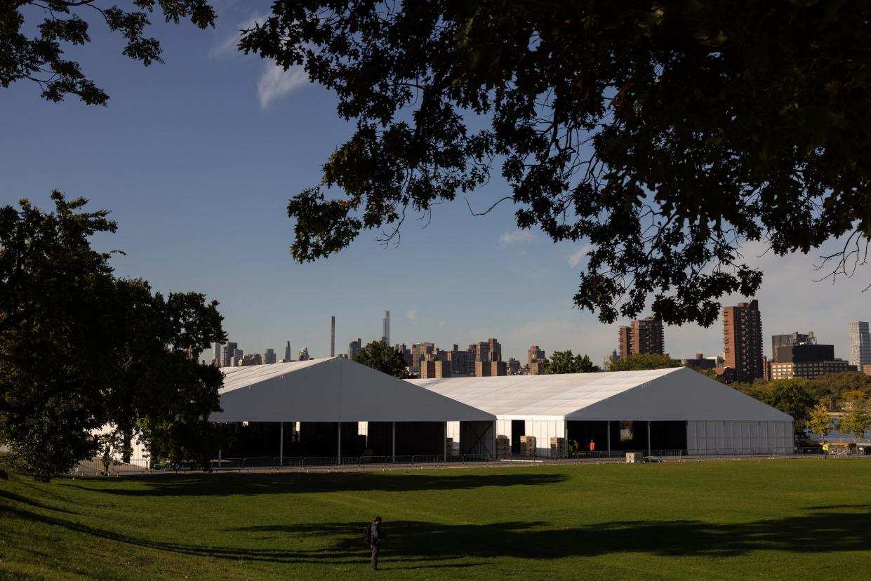 Workers construct shelters to help handle an influx of asylum-seekers, on Randalls Island in New York City on October 10, 2022. 