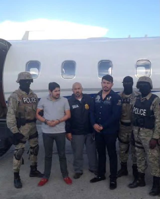 FILE PHOTO: Handout photo of Efrain Antonio Campo Flores and Franqui Fancisco Flores de Freitas stand with Haitian law enforcement officers in this November 12, 2015 photo after their arrest in Port Au Prince, Haiti.