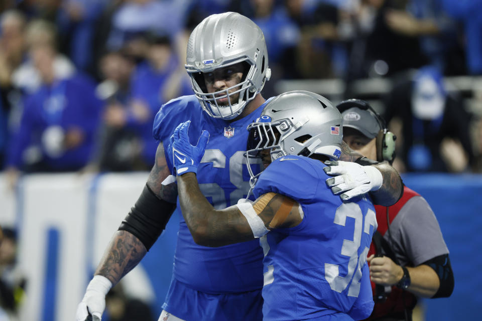 Detroit Lions running back D'Andre Swift (32) is hugged by offensive tackle Taylor Decker (68) after rushing for a 21-yard touchdown during the second half of an NFL football game against the Chicago Bears, Sunday, Jan. 1, 2023, in Detroit. (AP Photo/Duane Burleson)