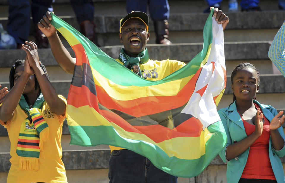 Supporters of Zimbabwean President Emmerson Mnangagwa are seen during his inauguration ceremony at the National Sports Stadium in Harare, Sunday, Aug. 26, 2018. Zimbabweans have begun arriving at a national stadium for the inauguration of President Emmerson Mnangagwa after a bitterly disputed election.(AP Photo/Tsvangirayi Mukwazhi)