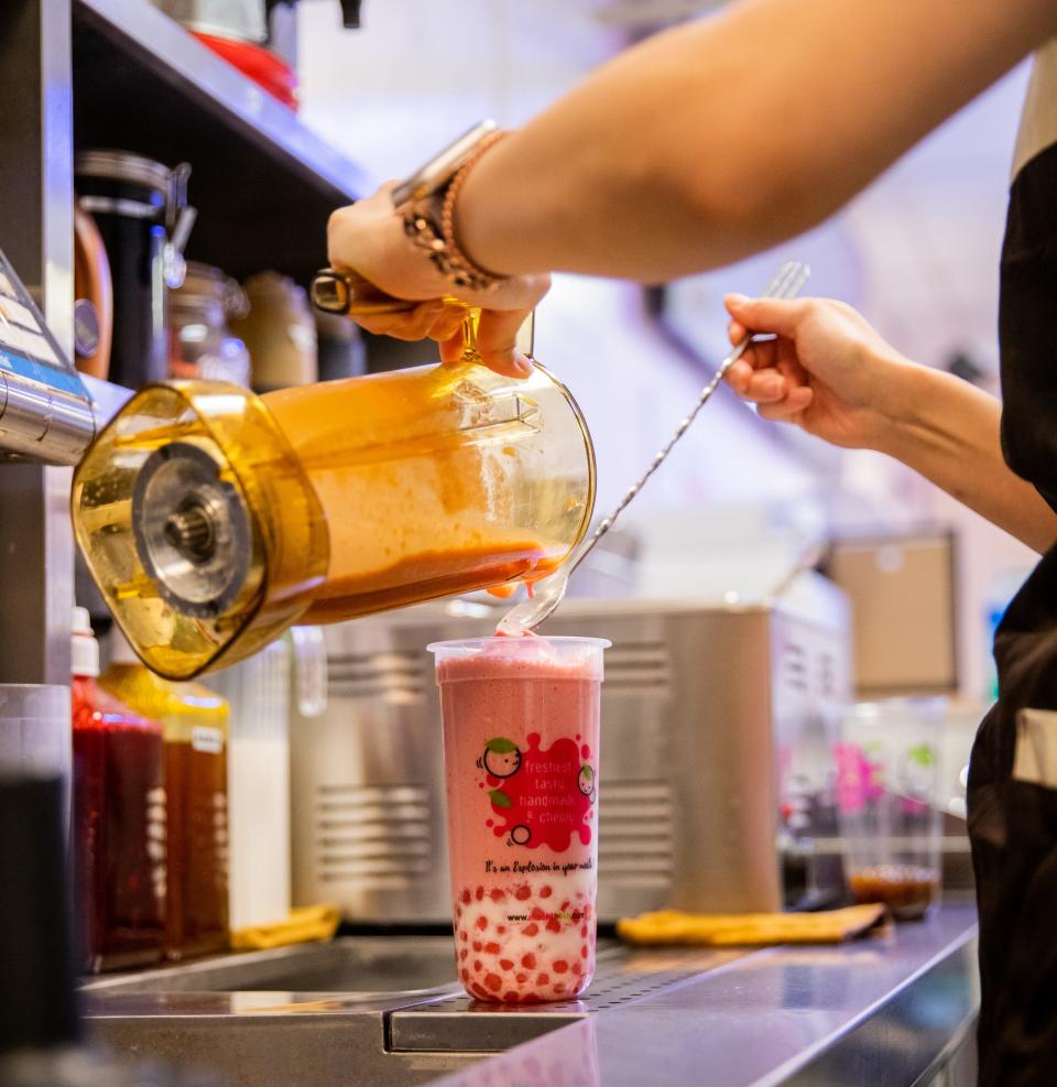 Rita Zhang pours a blended drink into a cup inside Mochi Fresh in Tempe on May 12, 2023.