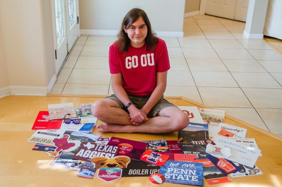 Gabe Cenker of Rockledge, now a junior at the University of Oklahoma, is pictured in 2021 surrounded by information from colleges which had accepted him. Cenker, like countless students nationwide, finds applying for scholarships a daunting task.