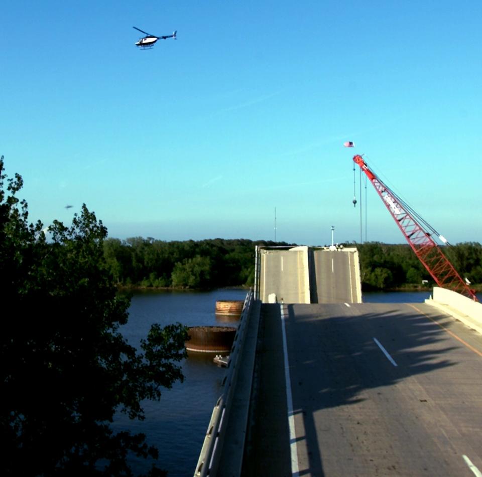 Oklahoma Highway Patrol helicopter searches the Arkansas River for victims of the collapse of Interstate 40 near Webbers Falls.