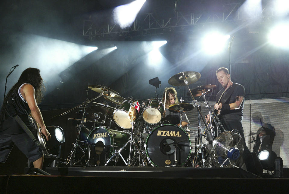 LEICESTERSHIRE, ENGLAND - JUNE 6:  Metallica perform with substitute drummer Dave Lombardo from Slayer on stage at day two of the 'Download Festival' at Donington Park on June 6, 2004 in Leicestershire, England. The rock festival features over 50 acts on three stages over two days. (Photo by Jo Hale/Getty Images)