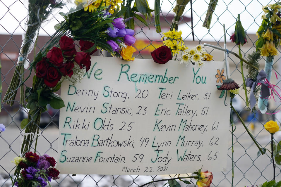 A handwritten sign bearing the names of the victims hangs on the temporary fence put up around the parking lot of a King Soopers grocery store where 10 people were killed earlier in the week in a mass shooting, Thursday, March 25, 2021, in Boulder, Colo. (AP Photo/David Zalubowski)