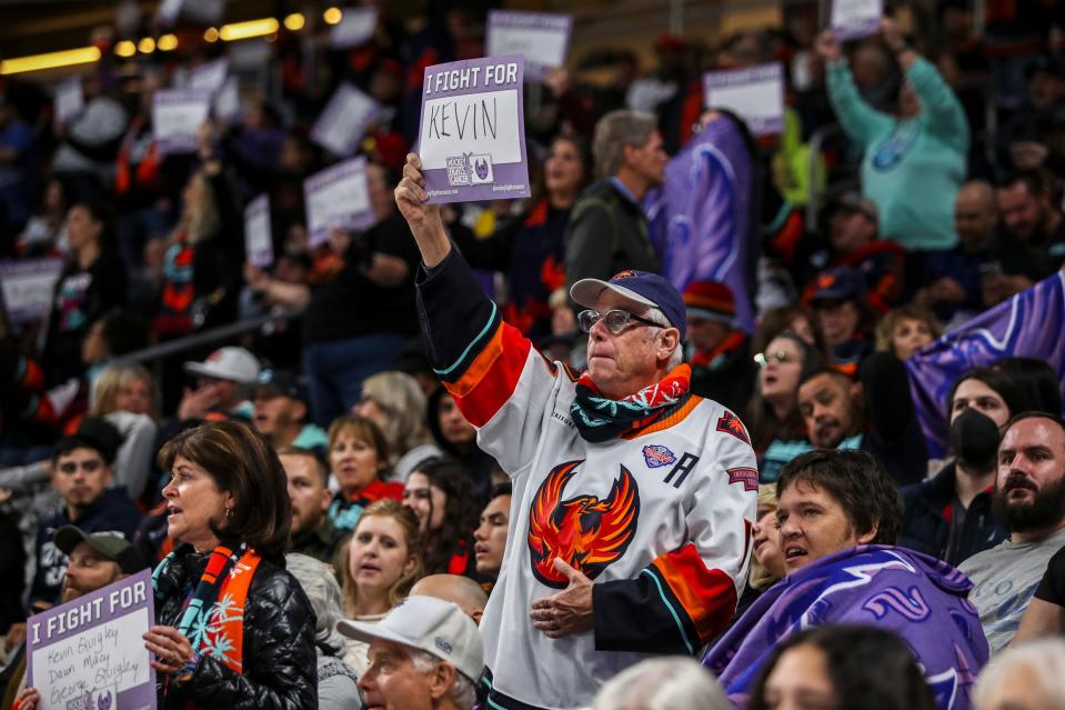 Coachella Valley Firebirds fans hold up signs with the names of cancer patients, survivors and victims alike during the third period of their game at Acrisure Arena in Palm Desert, Calif., Tuesday, Nov. 21, 2023.