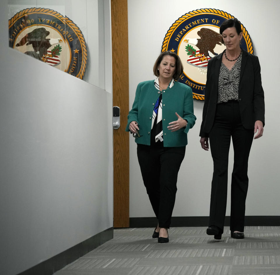 Deputy Attorney General Lisa Monaco, left, chats with Colette Peters, director of the federal Bureau of Prisons, after an interview with The Associated Press Tuesday, April 25, 2023, in Aurora, Colo. Monaco says teams of experts and officials will soon be fanning out to women’s prisons around the country to follow up on reforms the agency adopted last fall on sexual abuse in the nation's federal prisons. (AP Photo/David Zalubowski)