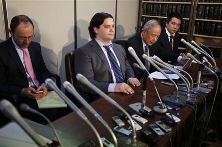 Mark Karpeles (2nd L), chief executive of Mt. Gox, attends a news conference at the Tokyo District Court in Tokyo February 28, 2014. Mt. Gox, once the world's biggest bitcoin exchange, filed for bankruptcy protection on Friday, saying it may have lost all of its investors' virtual coins due to hacking into its faulty computer system. Karpeles, bowing in contrition and wearing a suit instead of his customary T-shirt, apologised in Japanese at a news conference for the company's collapse, blaming "a weakness in our system." REUTERS/Yuya Shino