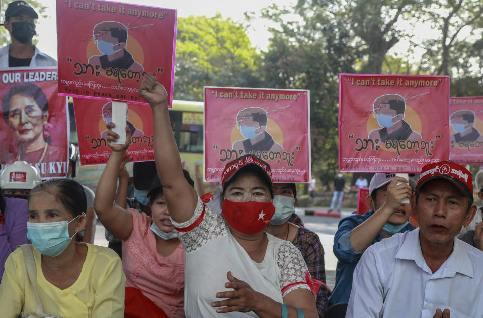 Anti-coup protesters display an image of protester who was shot and killed by Myanmar security forces during a protest two-days earlier as they gather to protest in Yangon, Myanmar Tuesday, Feb. 23, 2021. Protesters gathered in Myanmar's biggest city despite the ruling junta's threat to use lethal force against people who join a general strike against the military's takeover three weeks ago. (AP Photo)