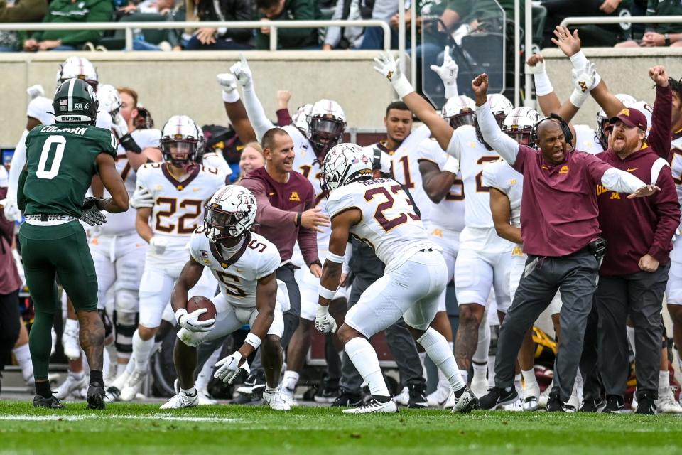 Minnesota's Justin Walley, center, and the bench celebrate after Walley's interception against Michigan State during the second quarter on Saturday, Sept. 24, 2022, at Spartan Stadium in East Lansing.