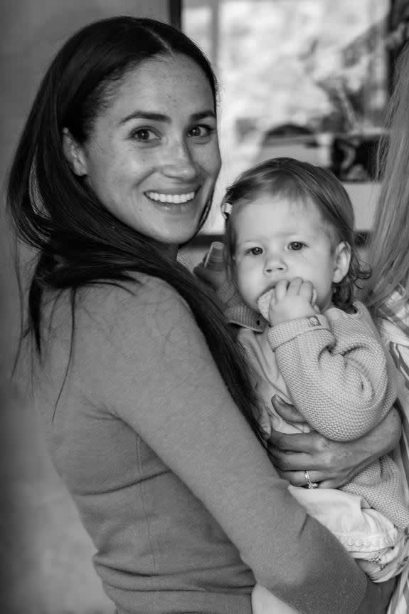 Meghan Markle holding daughter Lilibet during her first birthday party