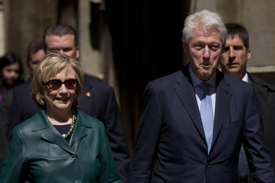 Former U.S. President Bill Clinton, right, and his wife former Secretary of State Hillary Rodham Clinton walk away after they attended their daughter Chelsea's Oxford University graduation ceremony held at the Sheldonian Theatre in Oxford, England, Saturday, May 10, 2014. Chelsea Clinton received her doctorate degree in international relations on Saturday from the prestigious British university. Her father was a Rhodes scholar at Oxford from 1968 to 1970. The graduation ceremony comes as her mother is considering a potential 2016 presidential campaign. (AP Photo/Matt Dunham)