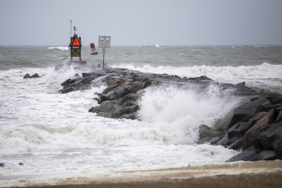 Waves break along the jetty at Rudee Inlet in Virginia Beach, Va., on Friday, Sept. 22, 2023, as Tropical Storm Ophelia approaches the area. Tropical Storm Ophelia was gaining strength as it churned toward the North Carolina coast on Friday, promising a weekend of heavy rain and windy conditions throughout the mid-Atlantic. (Kendall Warner/The Virginian-Pilot via AP)