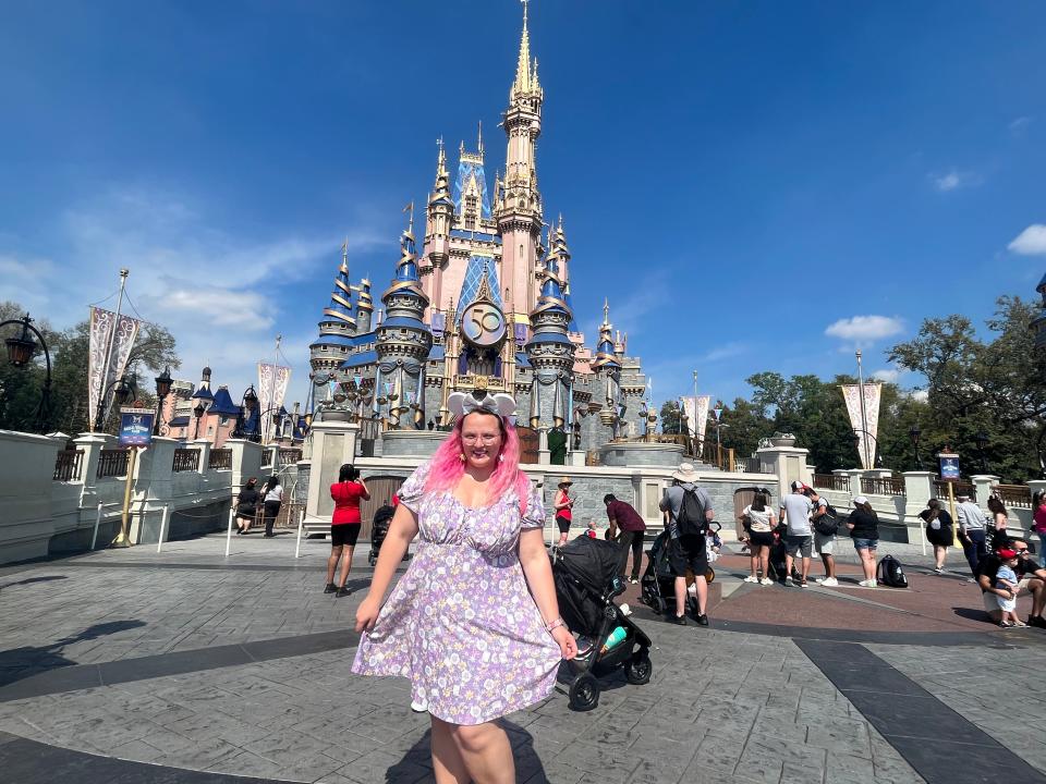 casey posing in front of cinderella castle at disney world