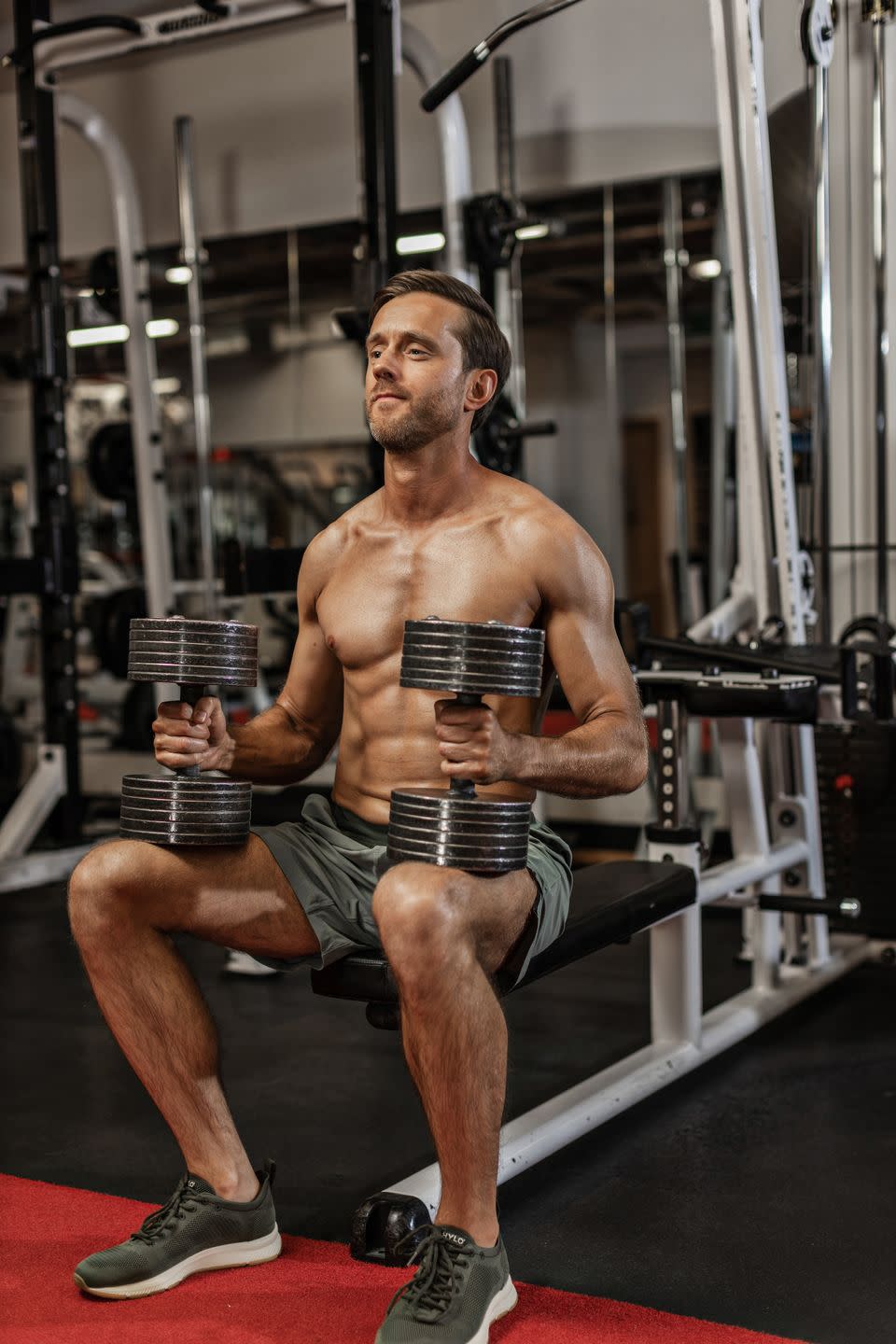 sitting down holding two dumbbells