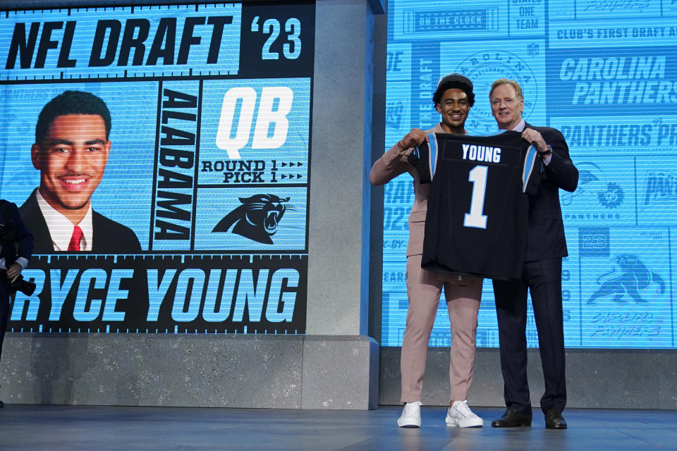 Alabama quarterback Bryce Young gets a jersey from NFL Commissioner Roger Goodell after being chosen by Carolina Panthers with the first overall pick during the first round of the NFL football draft, Thursday, April 27, 2023, in Kansas City, Mo. (AP Photo/Jeff Roberson)