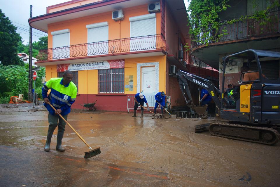 Employees work to clean the streets in Trois-Riviere, on October 22, 2023, on the island of Guadeloupe, after the path of Hurricane Tammy. Confined for a few hours on October 21, 2023 in the path of Hurricane Tammy, Guadeloupe has not yet seen the last of the bad weather: heavy rains fell on the archipelago on October 22, swelling rivers that have burst their banks and causing local flooding.