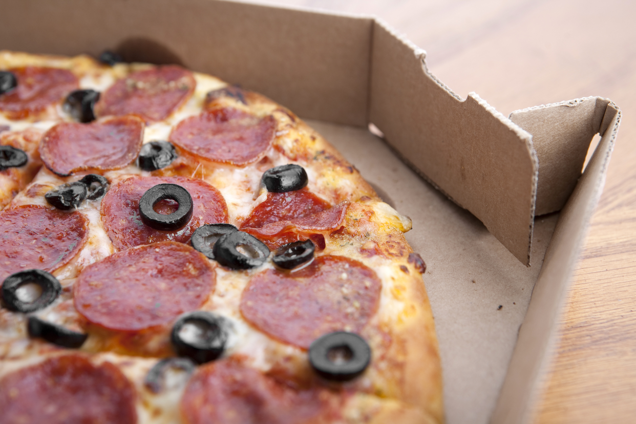 Pizza in a cardboard delivery box