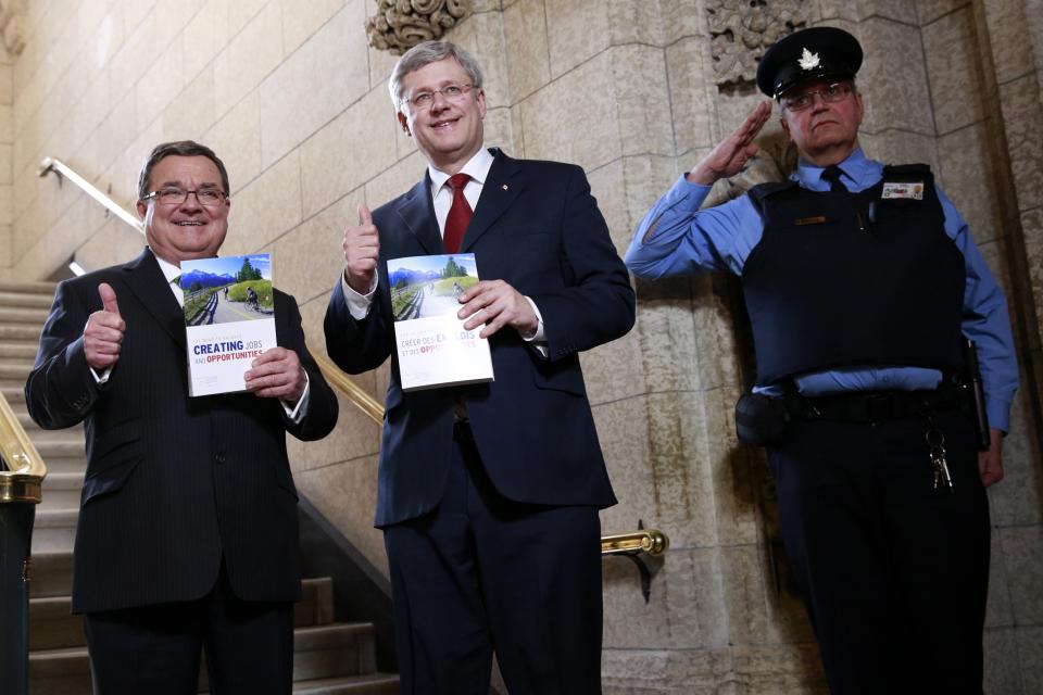 Canada’s Former Prime Minister Stephen Harper (C) and Finance Minister Jim Flaherty walk to the House of Commons to deliver the budget on Parliament Hill in Ottawa February 11, 2014. (Reuters)