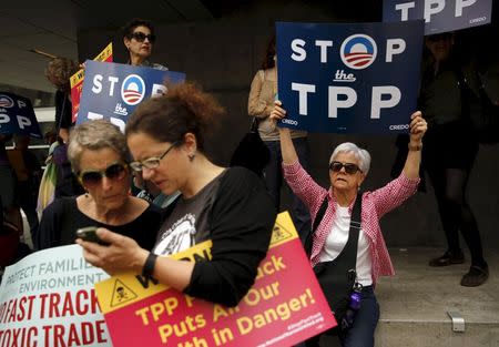 A group of demonstrators protesting the Trans-Pacific Partnership gather at the Federal Buileing in San Francisco, California June 9, 2015. REUTERS/Robert Galbraith