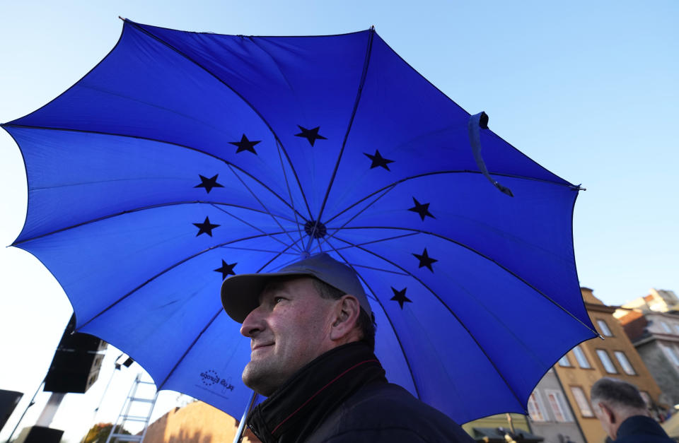 A man walks under an umbrella with the EU logo as he participates in a demonstration supporting Poland's EU membership, in Warsaw, Poland, Sunday, October 10, 2021. Poland's constitutional court ruled Thursday that Polish laws have supremacy over those of the European Union in areas where they clash, a decision likely to embolden the country's right-wing government and worsen its already troubled relationship with the EU. (AP Photo/Czarek Sokolowski)