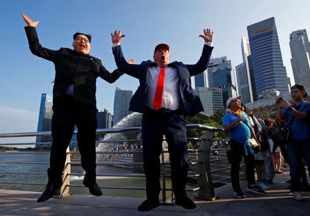 Howard, an Australian-Chinese impersonating North Korean leader Kim Jong-un, and Dennis Alan, impersonating U.S. President Donald Trump, meet at Merlion Park in Singapore June 8, 2018. REUTERS/Edgar Su