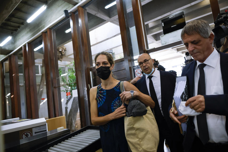 Aya Biran, center, a paternal aunt of Eitan Biran, the boy who survived a cable car crash in Italy that killed his immediate family, arrives to court in Tel Aviv Friday, Oct. 8, 2021. Biran's parents and younger sibling were among 14 killed in May when a cable car slammed into a mountainside in northern Italy. He is now the focus of a custody battle between his maternal grandparents in Israel and his paternal relatives in Italy. (AP Photo/Tsafrir Abayov)