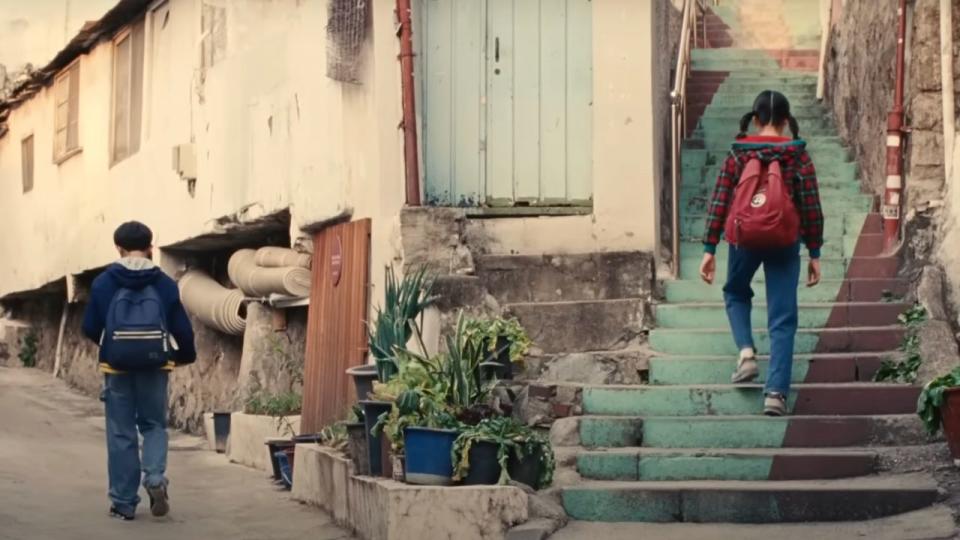 Nora and Hae Sung as children walking home in Korea