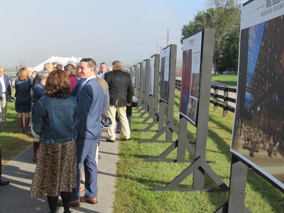 People stood in front of renderings on Oct. 19, 2021 of the planned Horse Soldier Farms project to create a bourbon distillery and other attractions in Somerset, Ky.