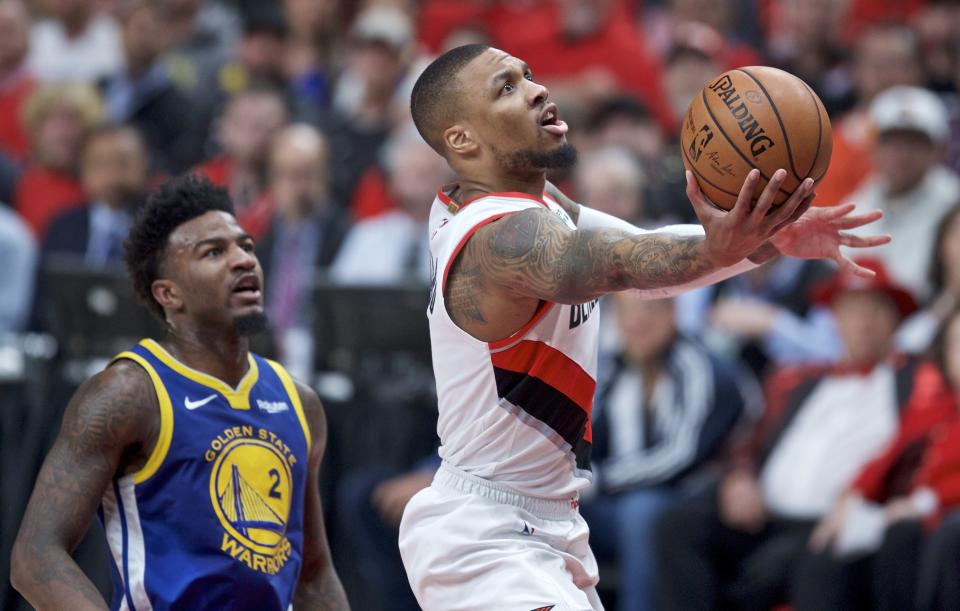 Portland Trail Blazers guard Damian Lillard, right, shoots near Golden State Warriors forward Jordan Bell during the first half of Game 4 of the NBA basketball playoffs Western Conference finals Monday, May 20, 2019, in Portland, Ore. (AP Photo/Craig Mitchelldyer)