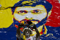 <p>A woman stands in front of a banner showing an image jailed opposition leader Leopoldo Lopez during a rally in Caracas, Venezuela, Feb. 18, 2017. (Photo: Ariana Cubillos/AP) </p>