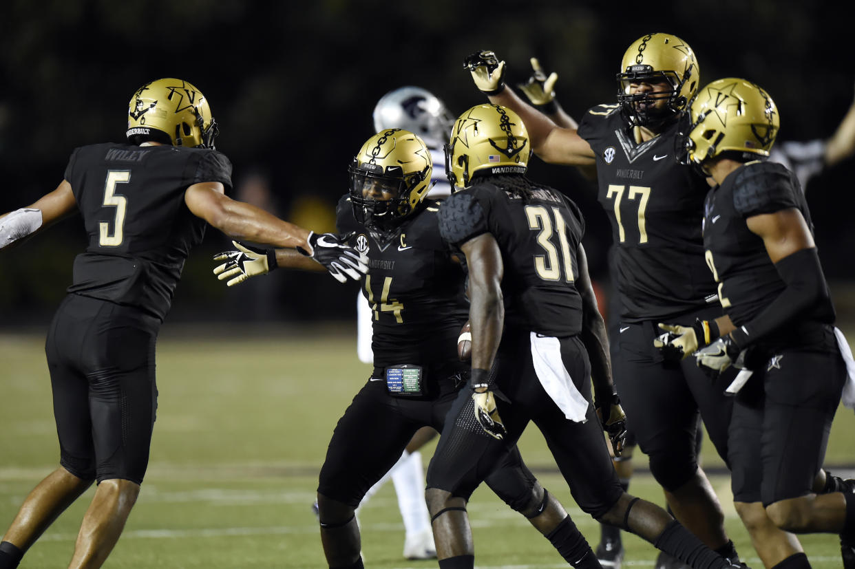 Vanderbilt safety Ryan White (14) celebrates LaDarius Wiley (5), Tre Herndon (31) and Nifae Lealao (77) after White intercepted a pass against Kansas State. (AP Photo/Mark Zaleski)