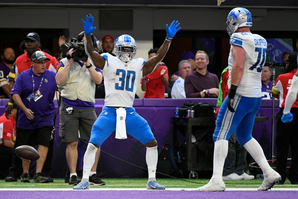 Lions running back Jamaal Williams celebrates after scoring on a 13-yard touchdown run during the second half on Sunday, Sept. 25, 2022, in Minneapolis.