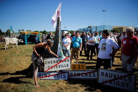 French dairy farmers from the FNSEA union gather as they block the round-about access to the Lactalis plant as they protest against the price of milk in Laval, France, August 23, 2016. REUTERS/Stephane Mahe